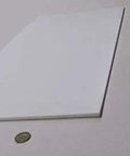 Sheet Three Sixteenth Inch Thick By Twelve By Twenty Four Inches Of PTFE for nonstick surfaces shown with coin for scale