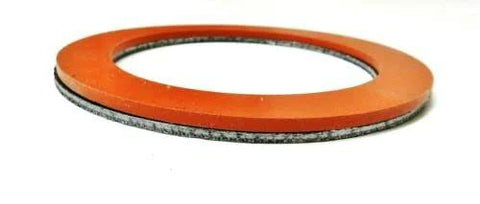 Close-up of a 3-1/2 inch orange silicone rubber gasket with graphite inner layer for vacuum casting perforated flask.