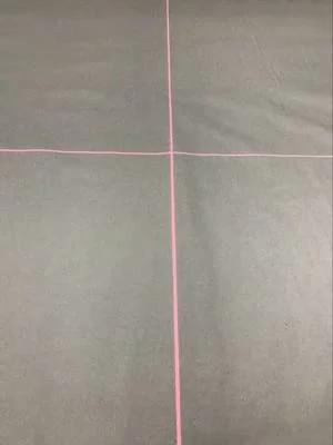 Crosshair alignment tool with red cross lines on a dark gray surface