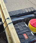Truck bed loaded with a wooden plank secured by 50 Pack 21 Inch Natural Rubber Tarp Bungee Straps With S Hooks Tie Downs
