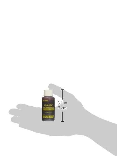 Tracer Products TP-3090-0601 gas engine oil dye bottle held in an open hand; amber bottle with white cap, 3.1 in tall.