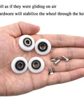 23mm diameter bearing steel shower door wheels with nylon rollers and stainless steel screws in hand, smooth installation parts