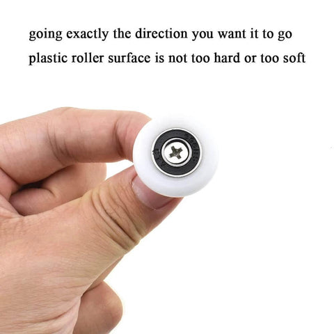 Hand holding 23mm diameter bearing steel shower door wheel with nylon roller and stainless steel screw close-up view