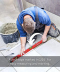 A person using a 24 inch box level with three durable acrylic vials, precise 1/16 inch ruler, wall grip, and hand calibrated straightedge on tiled floor.