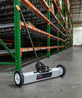 24 Inch Rolling Magnetic Floor Sweeper With 50 Pound Capacity And Adjustable Handle From 29 To 42 Inches With Floor Magnet Clearance Height For Fast Safe Pickup Of Nails Screws And Ferrous Metal Debris On Construction Jobsites And Shop Floors on warehouse floor.