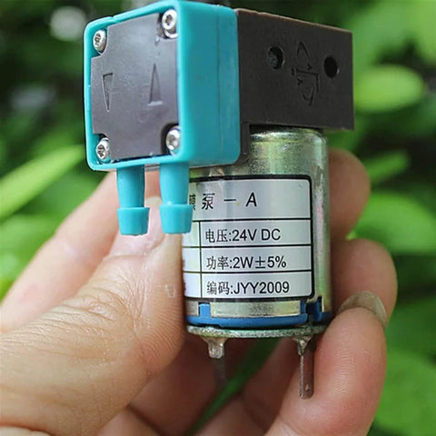 Close-up of a compact 24V Mini Diaphragm Pump, 2W Micro Liquid Water Pump, shown in hand for lab analysis and precise metering.