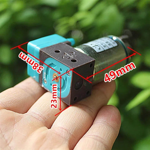 24V Mini Diaphragm Pump, 2W Micro Liquid Water Pump, shown on hand for size reference, 49mm x 38mm x 23mm dimensions