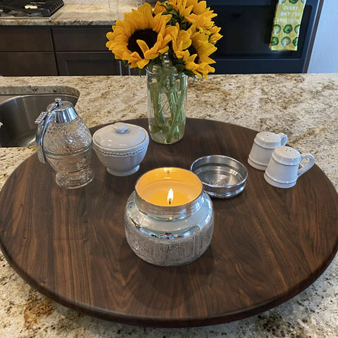 24 Inch Black Walnut Wood Lazy Susan Round Turntable on countertop with decor items and candle centerpiece