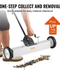 Effortless, heavy duty rolling magnetic sweeper with a 24 inch wide magnet and 50 lb pickup capacity in use on a workshop floor.