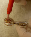 Using Brush Plating Kit With 24K Gold Solution Complete Gold Plating System for precise gold finish on a coin.