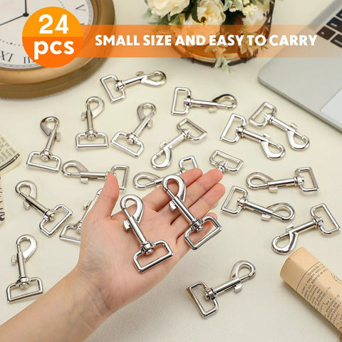 Hand holding 24 Pack Swivel Snap Hooks For Dog Leashes Heavy Duty 2.76 Inch Flag Clasp Clip Hooks displayed on table.