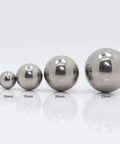 Four different sizes of mirror-finish steel balls - 5mm, 10mm, 15mm, 20mm, and 25mm diameter for garden decor and precision projects