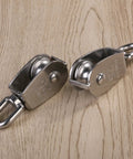 Two Pack 25mm 304 stainless steel pulley blocks with a 400 kg rating deliver reliable lifting, hauling, and rigging on wooden surface.
