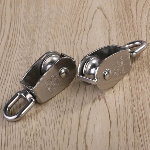 Two Pack 25mm 304 stainless steel pulley blocks with a 400 kg rating deliver reliable lifting, hauling, and rigging on wooden surface.