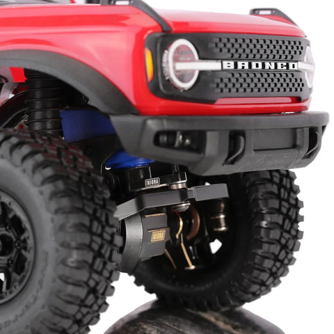 Close-up of 1/18 TRX4M with 25T Servo Horn Upgrade installed, featuring aluminum CNC machined construction in black and red anodized finish.