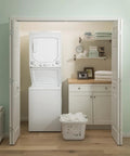 Compact 27 inch unitized washer and electric dryer in one space-saving cabinet in a laundry closet setup.