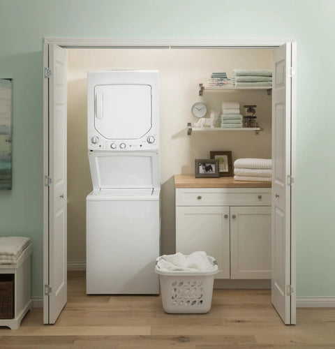 Compact 27 inch unitized washer and electric dryer in one space-saving cabinet in a laundry closet setup.