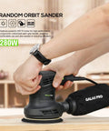 280W Orbital Sander 13000 RPM With Dust Collection And 15 Discs in use, showing ergonomic grip and dust bag attachment.