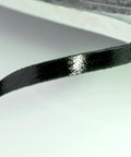 Close-up of 2mm double-sided adhesive tape for smartphone, tablet, and laptop LCD digitizer repair, showing glossy surface texture.