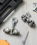 2 Pcs 4 Wheel Silent Trolley Assembly Rollers with Hidden Bolt Design shown with tools on a wooden surface