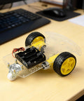 2WD Robot Car Chassis Kit With TT Motors Battery Box Acrylic Chassis And Two Wheels For DIY Projects on a desk