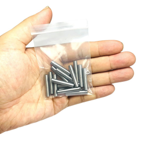 Hand holding Heavy Duty 3/16 Inch By 1 Inch Dowel Pins 15 Pack For Woodworking And Shelving Alloy Steel Ground Precision Pins