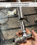 Hand holding chromoly spherical rod end from 3/4 inch Heim joint rod end kit with jam nuts, metal workspace background