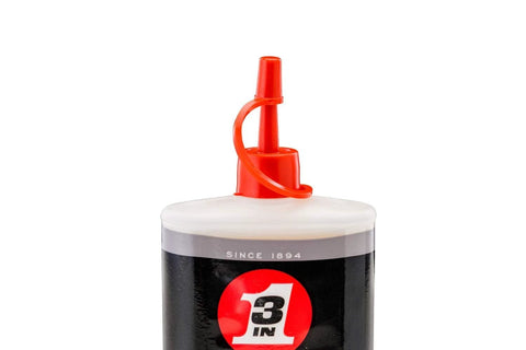 Close-up of the top of a 3-IN-ONE Multi-Purpose Oil, 8 OZ bottle, showing red twist spout and part of the black and white label.