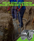 Workers using 3 Inch Feeding Sheave For Greenlee Tuggers 640 6801 6001 in trench with aluminum roller for conduit feeding.