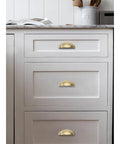 10 Pack 3 Inch Champagne Bronze Cup Drawer Pulls For Cabinets And Furniture Durable Solid Metal Kitchen Hardware installed on white drawers
