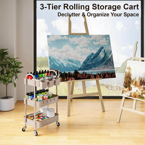 Khaki 3 Tier Metal Utility Rolling Cart With Lockable Wheels And Mesh Storage Baskets Your Go-To For Kitchen Office Living Room Laundry Garage And A Versatile Organizer For Snacks Tools Craft Supplies next to art canvas and easel