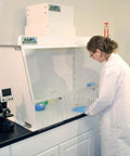 Lab technician using 30 Inch Wide Portable Laminar Flow Hood Lab Grade For Medical And Laboratory Use with positive pressure