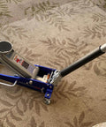3000 Lb Aluminum Racing Car Auto Floor Jack Low Profile Rapid Pump Lift shown on carpet, handle extended, blue frame visible