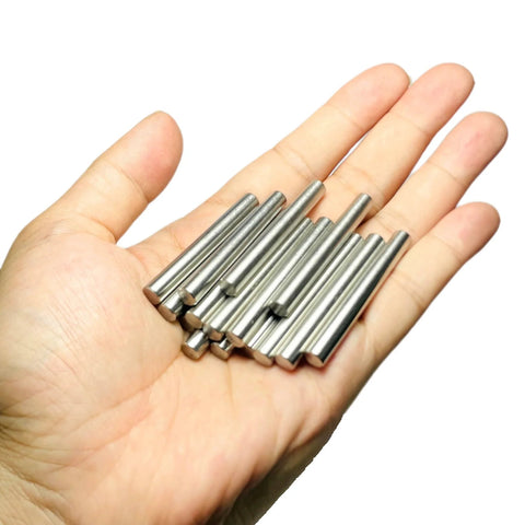 Hand holding sturdy 6mm dowel pins set for shelves and woodworking, 15 pack, 50mm length, 304 stainless steel, M6 dowels, ground.