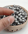 Hand holding 304 Stainless Steel Threaded Steel Ball, Half-Hole Threaded Steel Ball, M2 Drilled Threaded Steel Ball, Round Nut, Thread Diameter 2mm, Steel Ball Diameter,20mm*3pcs, showing threaded hole and polished surface, with more balls in a basket