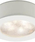 LED Round Button Light 3000K White With Recessed Or Surface Mount Low Profile Fixture, illuminated close-up view showing light diffusion.