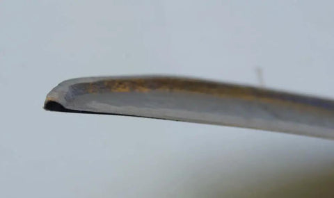 Close-up of an 11-inch blade edge from a Hand Scythe With An 11 Inch Blade For Harvesting Grass And Weeds Reaping Sickle Style Grass Hook