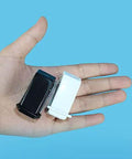 Hand holding Two Pack Small Black And White One Quarter Inch Circle Hole Punch Handheld Tool for paper and leather craft, blue background.