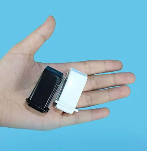 Hand holding Two Pack Small Black And White One Quarter Inch Circle Hole Punch Handheld Tool for paper and leather craft, blue background.