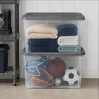 Tackle The Mess Fast With This Beast Mode 108 Quart Stackable Storage Bin Packing. Clear bins holding blankets and sports equipment.