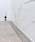 48 Inch Linear Shower Drain Slick Brushed Nickel Stainless Steel Side Outlet Offset Bundle With Rubber Gasket And Super Fine Hair Strainer For Modern Bathroom Plumbing Smooth Flow Top Tier Traditional Square Design Easy Setup on tiled floor.