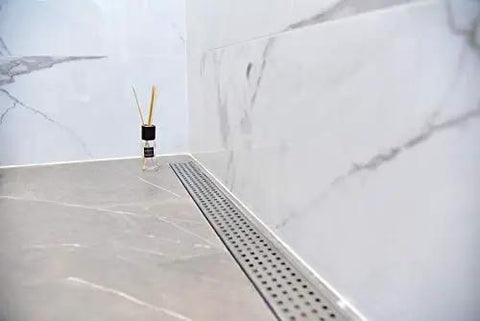 48 Inch Linear Shower Drain Slick Brushed Nickel Stainless Steel Side Outlet Offset Bundle With Rubber Gasket And Super Fine Hair Strainer For Modern Bathroom Plumbing Smooth Flow Top Tier Traditional Square Design Easy Setup on tiled floor.