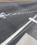 3/16-IN X 10-FT Heavy Duty Proof Coil Chain, Bright Zinc-Plated Metal Chain, installed outdoors along a curved road