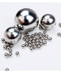 Group of 100Pcs 0.3mm Solid 316L Stainless Steel Ball - Smooth Beads Round Balls displayed on a surface.