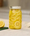 Real Deal Wide Mouth Glass Mason Jars With Lids And Bands For Canning And Pickling Quart 32 Oz Pack Of 2 with sliced lemons.