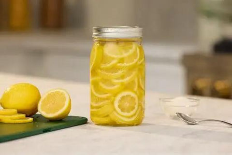 Real Deal Wide Mouth Glass Mason Jars With Lids And Bands For Canning And Pickling Quart 32 Oz Pack Of 2 with sliced lemons.