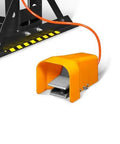 Foot pedal control of Beefy 30 Ton H Frame Air Hydraulic Shop Press, part of steel frame with orange pedal and cable visible.