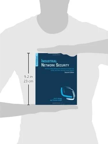 Front view of blue book by Amazon, Industrial Network Security, held by a person; about 9.2 in tall.