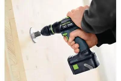 A hand holding the Professional 18V Cordless Drill And Driver Tool With Quick Change Chuck System drilling into wood.