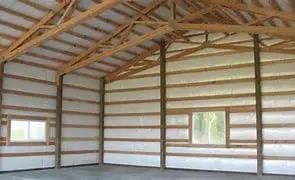 Interior view of a metal building with Top Shelf 2 Inch Fiberglass Insulation Roll With Psk Facing for thermal shielding.